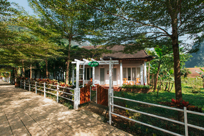 Rustic house surrounded by a green garden