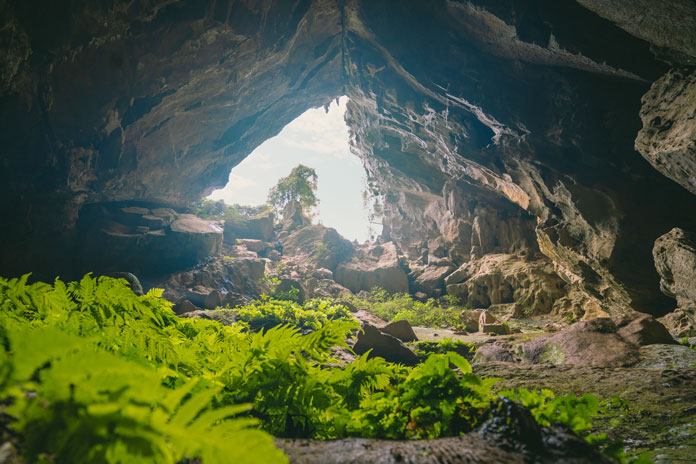 Rat Cave has a large and relatively even chamber with a tall and unique cave entrance.