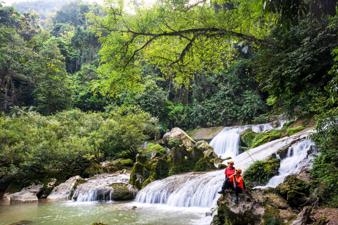 A beautiful waterfall behind Kim Cave entrance.