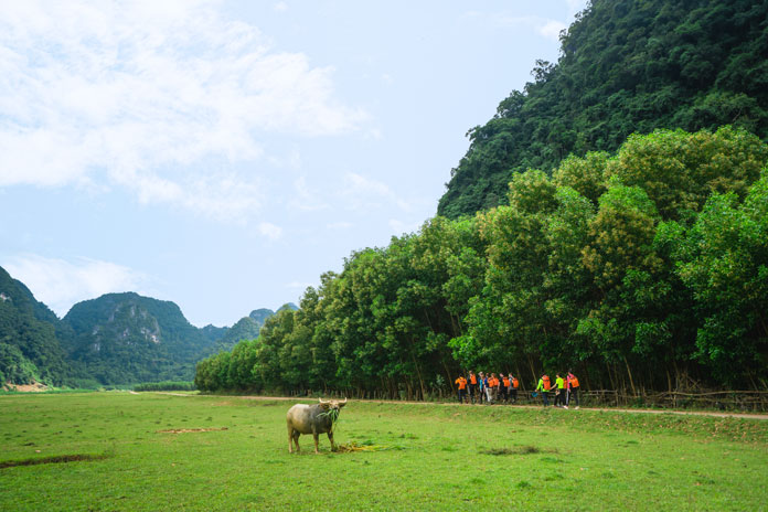 The trek starts with a flat path past the green field.