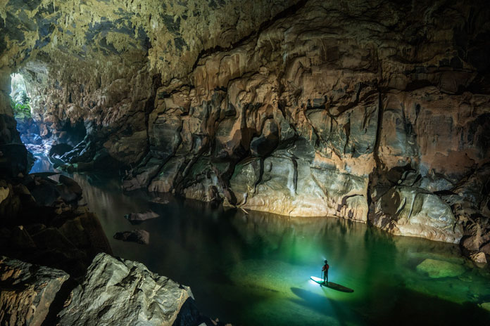 Guests can use a SUP to explore and get out through the Hang Ba